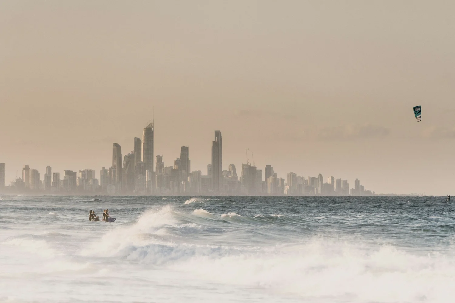 City skyline with beach and kitesurfer